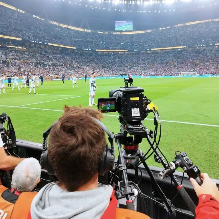 Camera operator at pitch level during an Argentina match at the 2022 World Cup in Qatar